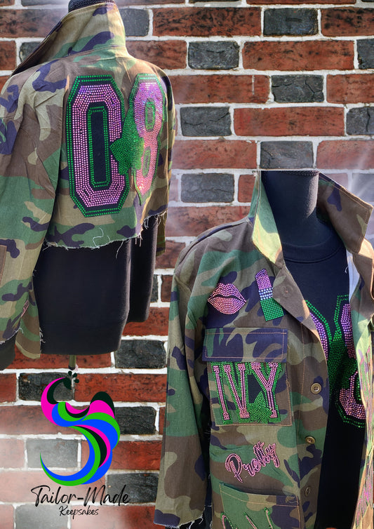 Show your Pretty Girl pride in this standout AKA camo jacket – a lightweight, unlined shirt-style jacket adorned with handmade pink and green spangle patches that sparkle with purpose. Whether you're strolling through campus, heading to chapter events, or repping your legacy, this camo jacket combines style, comfort, and sorority sisterhood.

