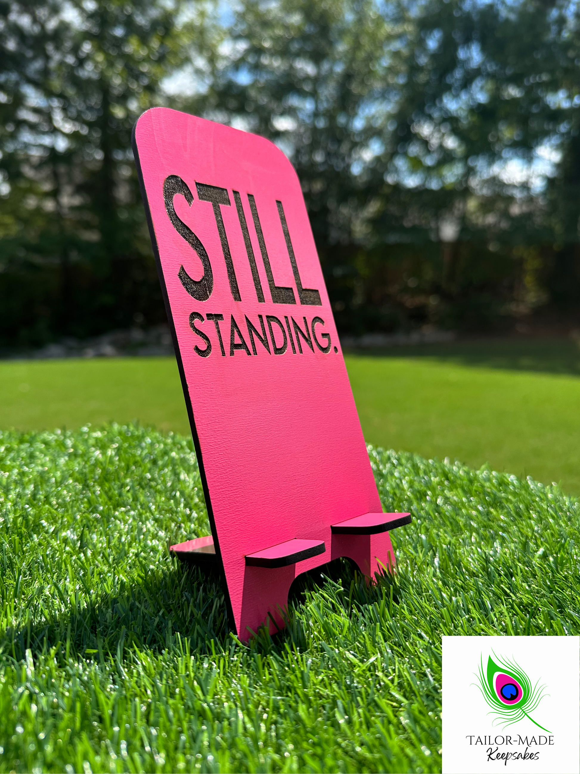 Pink Still Standing laser engraved statement phone stand, motivational desk decor with black lettering, handmade MDF sign for empowerment gifts